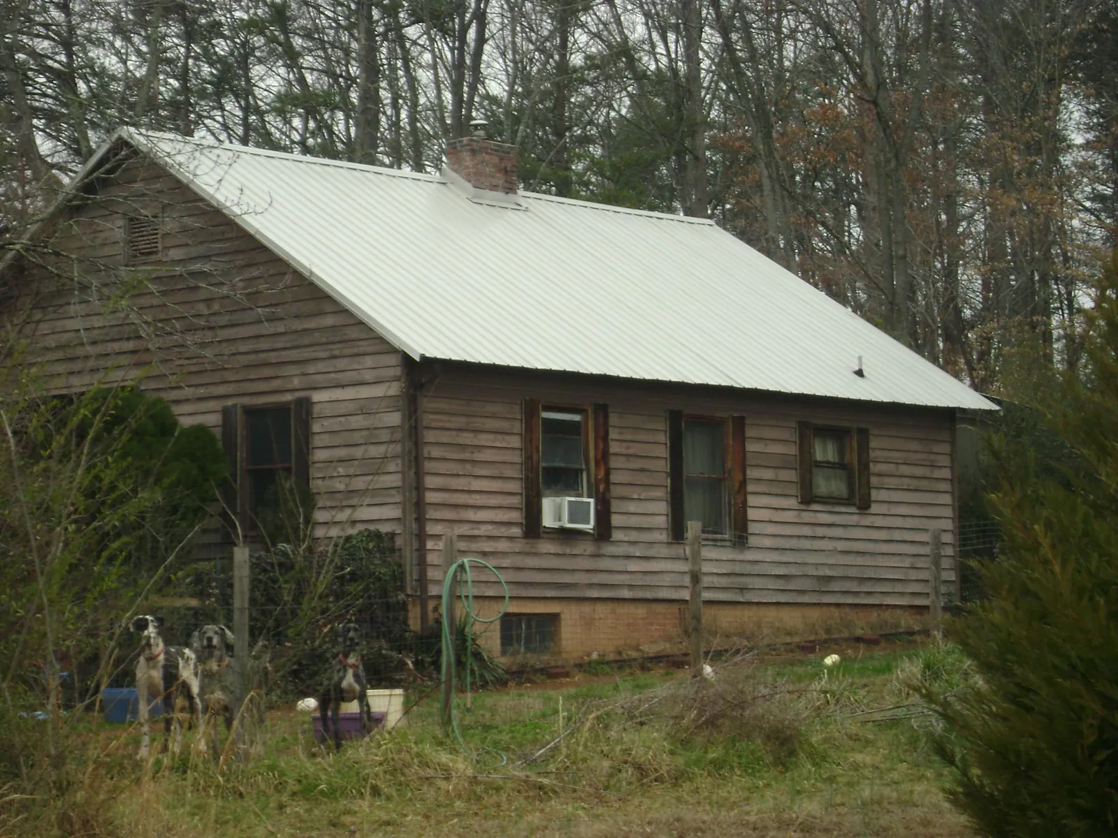 White metal roof on an old wood sided farmhouse, from a Metal Roof Installation job in West Newton